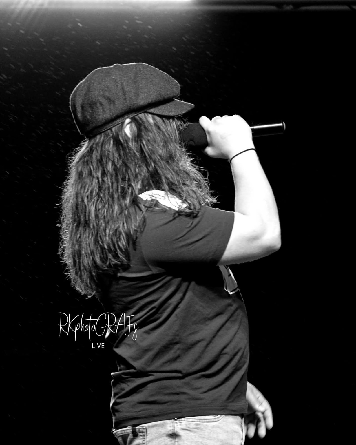 AC/DC ERAS vocalist performing in a flat cap