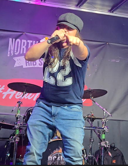 Kyle Dame performing as Brian Johnson